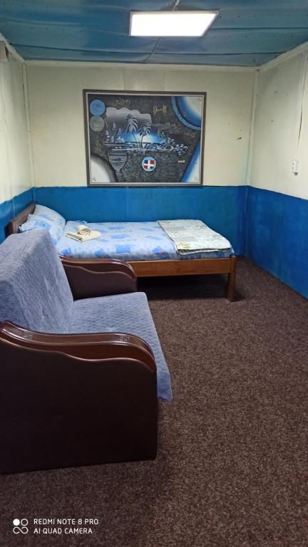 a room with two beds and a couch in it at Бюджетне житло in Kunovka