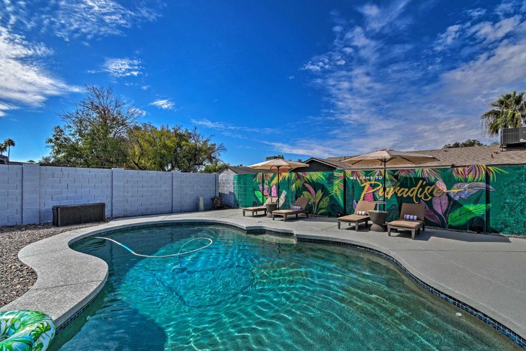 a swimming pool in a yard with chairs and umbrellas at Boho Paradise Valley with Pool Near Scottsdale! in Phoenix