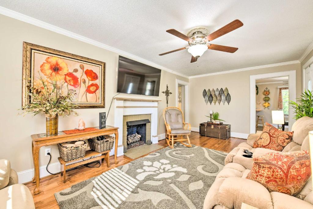 a living room with a ceiling fan and a fireplace at Belmont Retreat about 14 Mi to Dtwn Charlotte! in Belmont