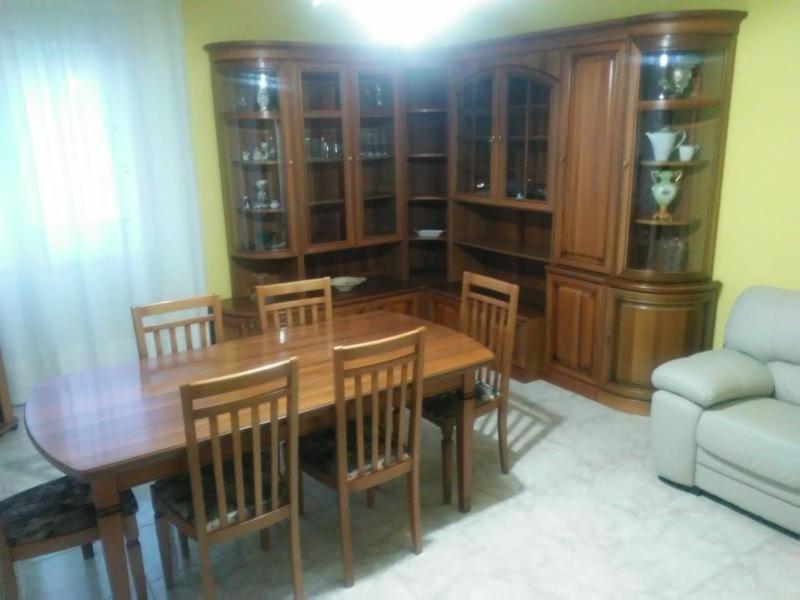 a dining room with a wooden table and chairs at B&B La Dea Maja in Fara Filiorum Petri