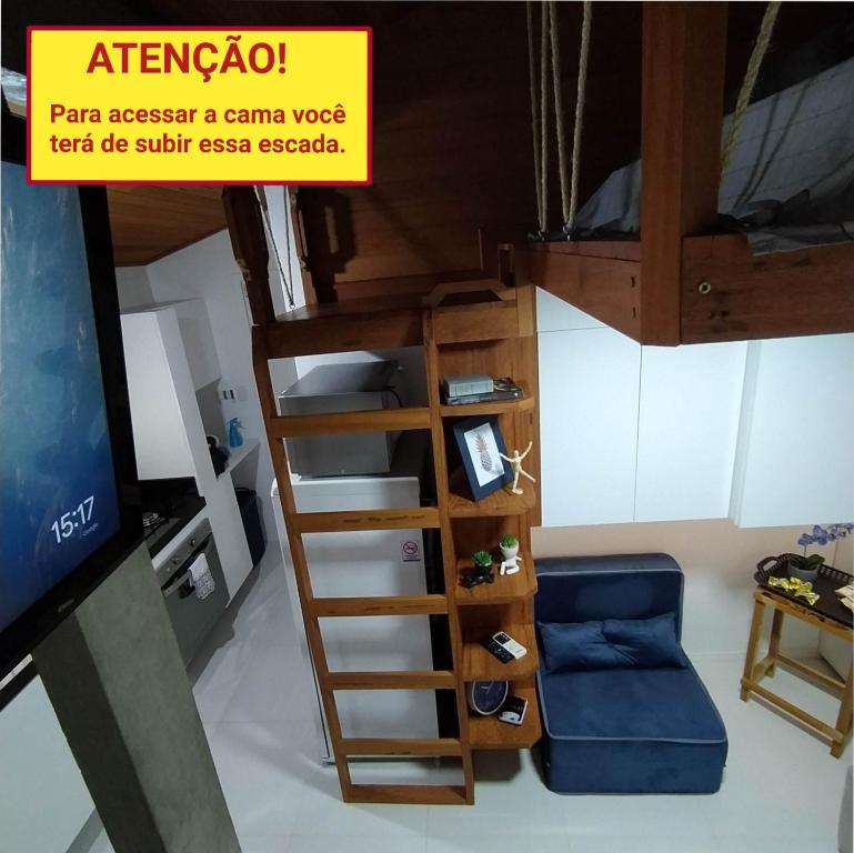 a room with a bunk bed with a ladder and a couch at Loft encantador D - 8 km de Floripa in São José