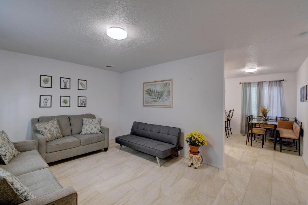 a living room with two couches and a table at NEWLY RENOVATED home located in the heart of ABQ in Albuquerque