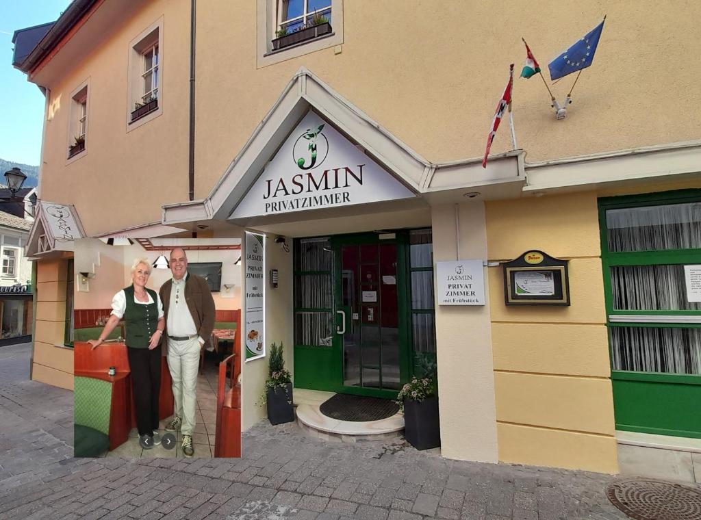 a man and a woman standing outside of a building at Jasmin Privatzimmer in Murau