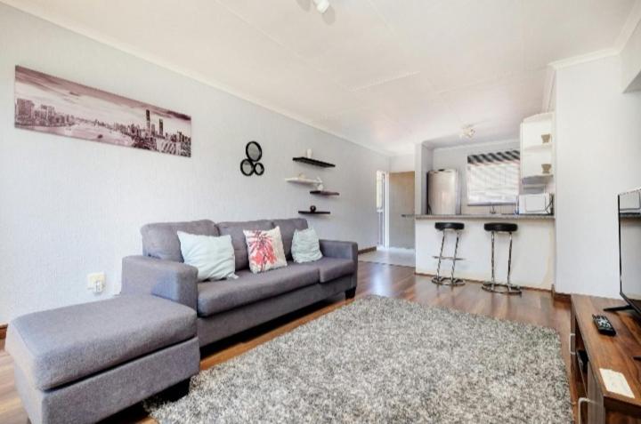 a living room with a couch and a table at The Resting Nest in Midrand