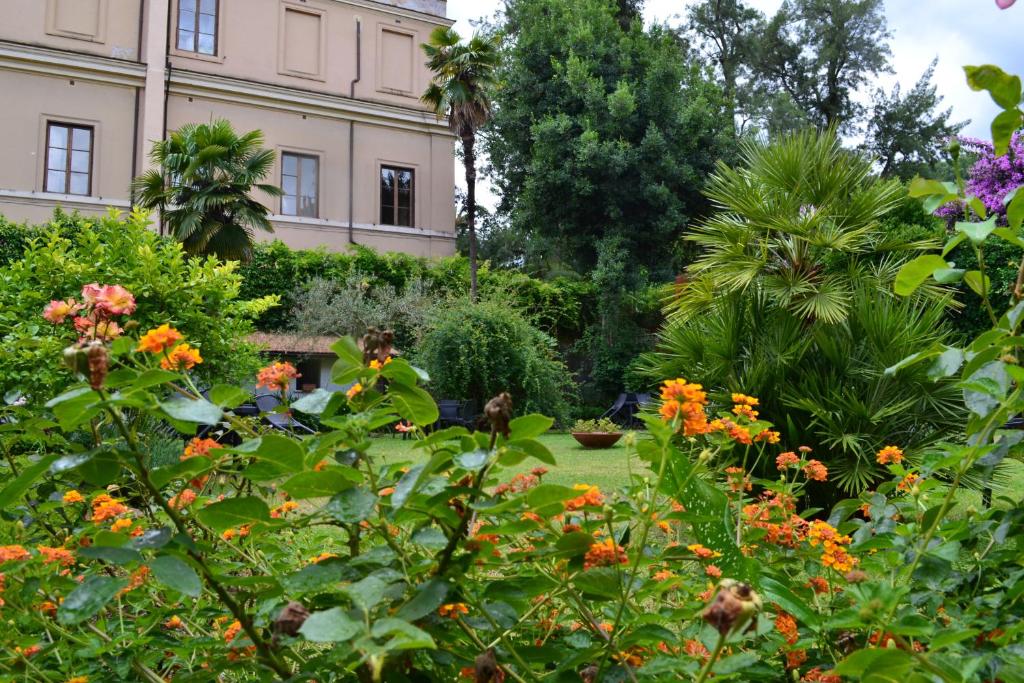 a garden with flowers in front of a building at Villa Riari Garden in Rome