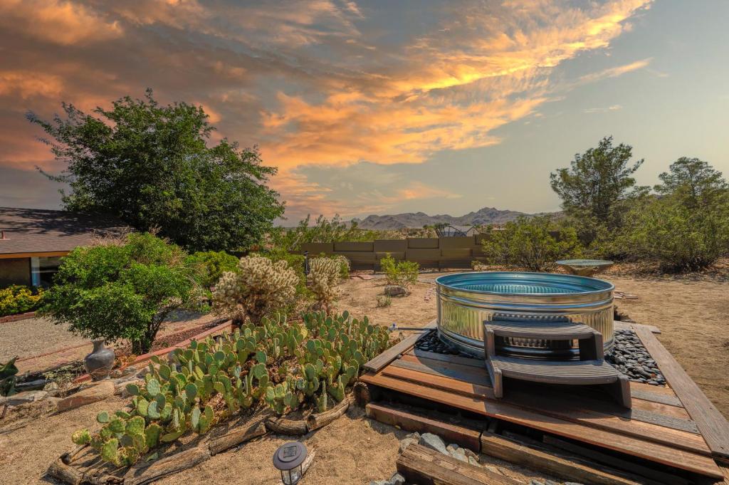 a garden with a large bucket in the middle of it at @ Marbella Lane - The Wine Mine Desert Escape in Joshua Tree
