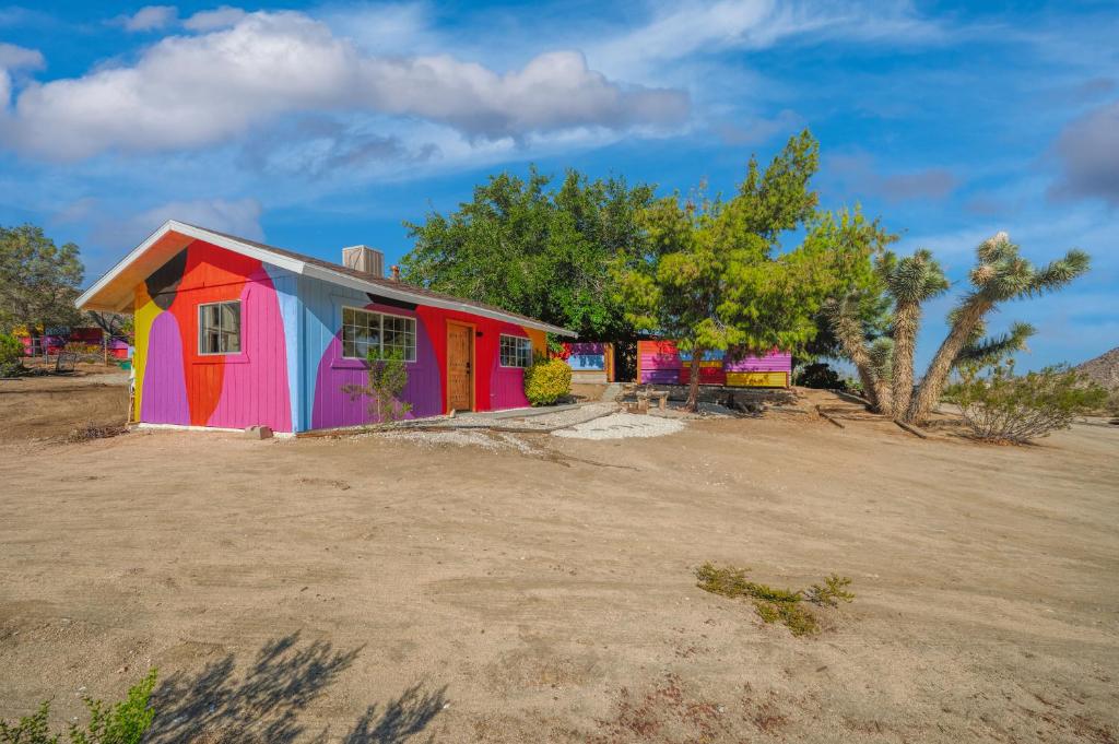 a colorful house in the middle of a field at @ Marbella Lane - Rainbow House Glampers Paradise in Joshua Tree