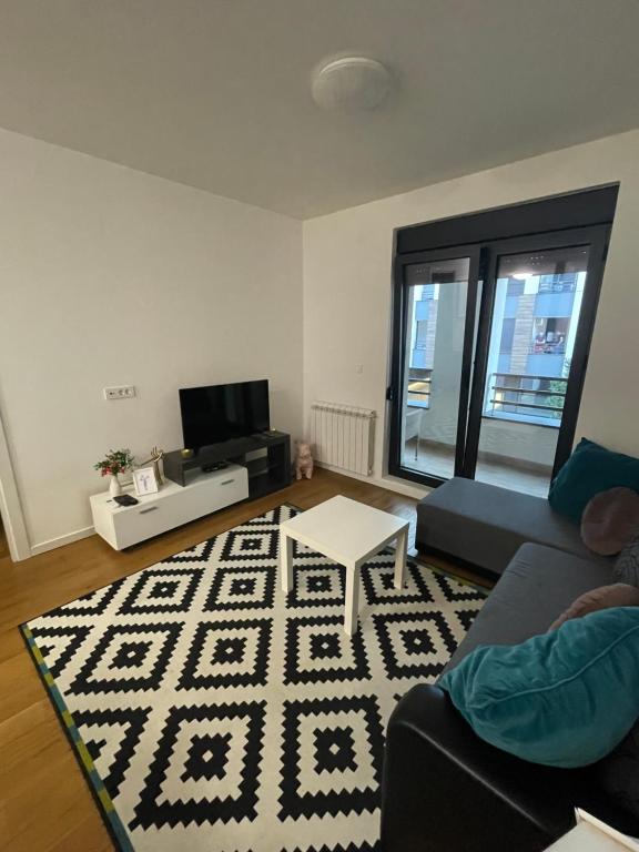 a living room with a couch and a rug at NEVA APARTMENT in Belgrade