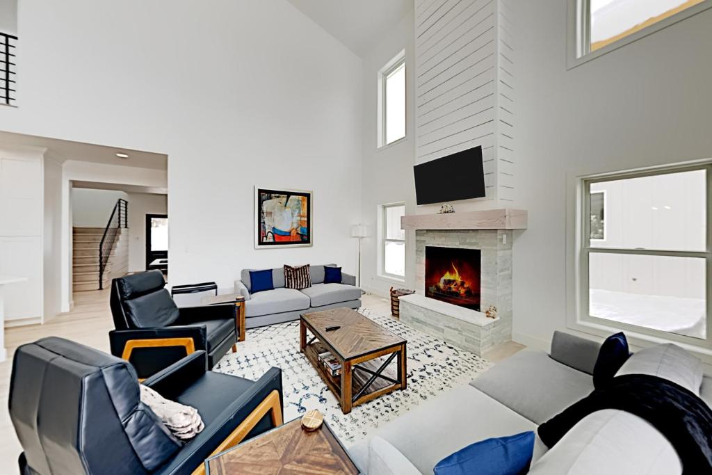 a living room with couches and a fireplace at Sunlight cottage in Steamboat Springs
