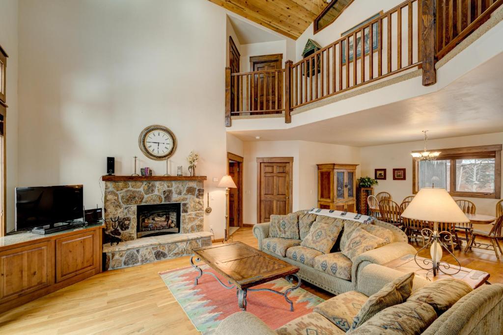 a living room with a couch and a fireplace at Bear Creek Retreat in Steamboat Springs