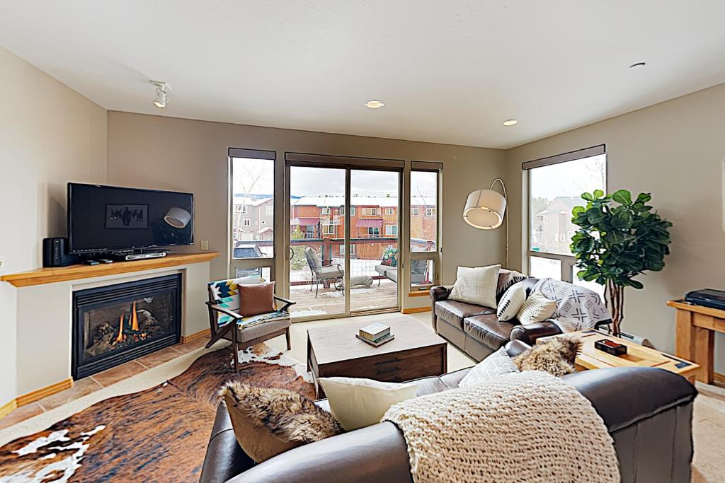 a living room with a couch and a fireplace at WinterStar E-2 in Fraser