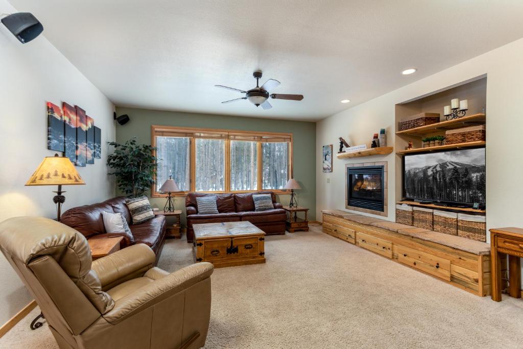 a living room with a couch and a tv at Big Bear Palace in Fraser