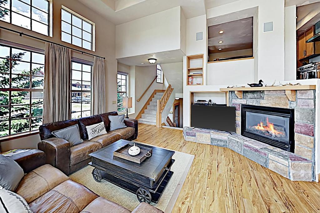 a living room with a couch and a fireplace at Red Quill Village in Winter Park