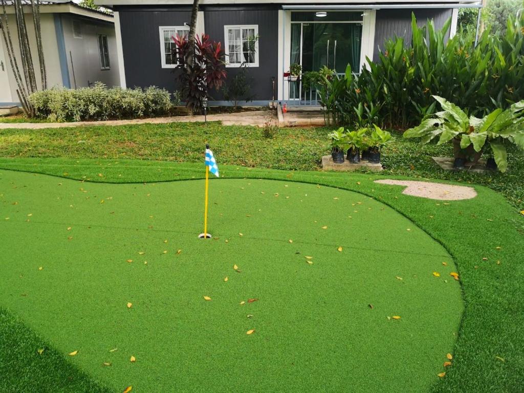 a golf course with a flag in the grass at Titiwangsa Cabin Retreats by Vale Pine in Kuala Lumpur