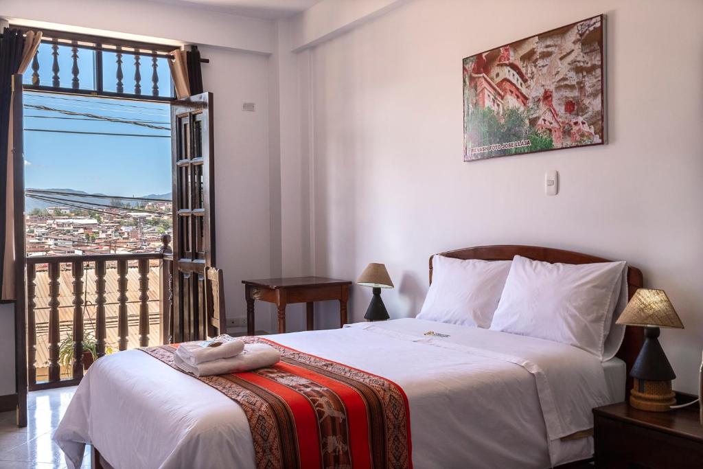 a bedroom with a bed and a window with a view at Chachapoyas Backpackers Hostal Boutique in Chachapoyas