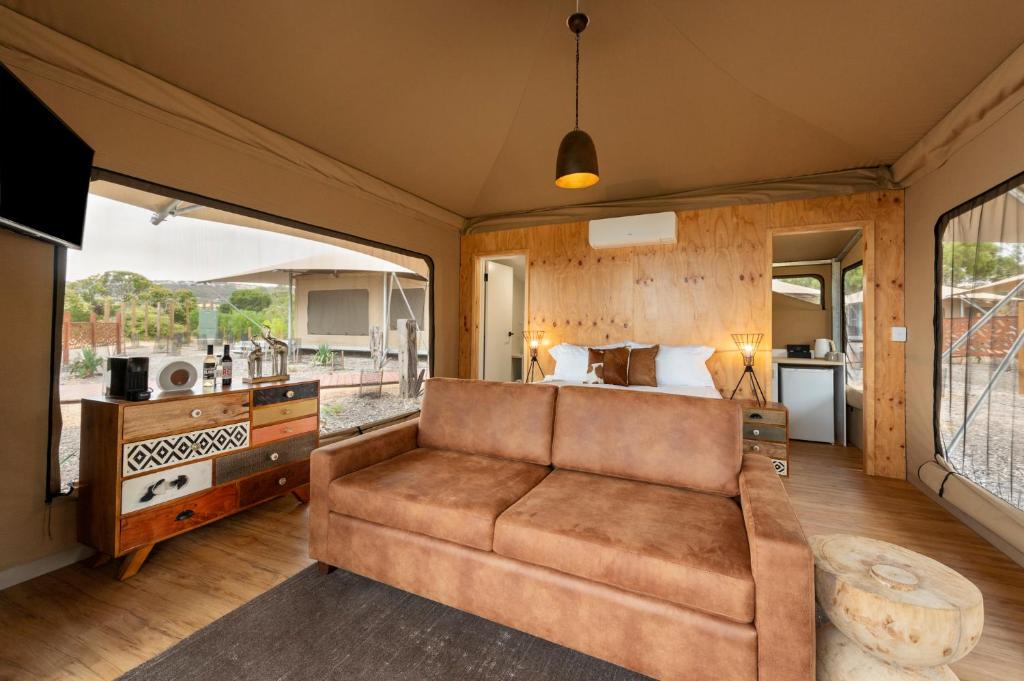 a living room with a couch and a coffee table at KI Seafront Holiday Park in Penneshaw
