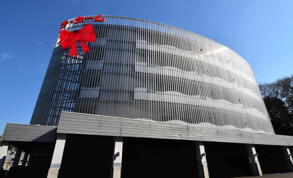 a large building with a red bow on it at HOTEL LaCalme in Moniwa