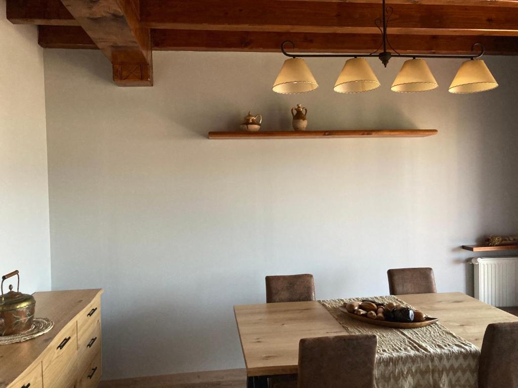 a dining room with a wooden table and chairs at Casita Planes Surroca in Bourg-Madame
