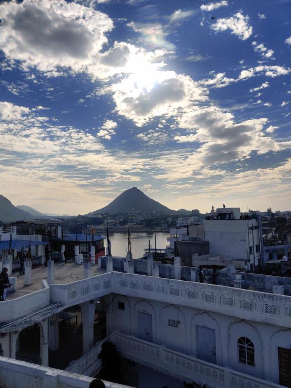 een uitzicht vanaf het dak van een gebouw met een berg op de achtergrond bij Varah Square Guest House in Pushkar
