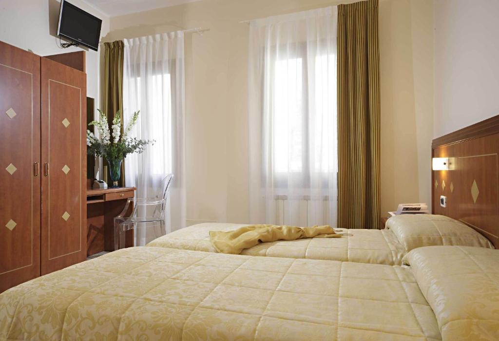 Postel nebo postele na pokoji v ubytování Hotel Adriatico