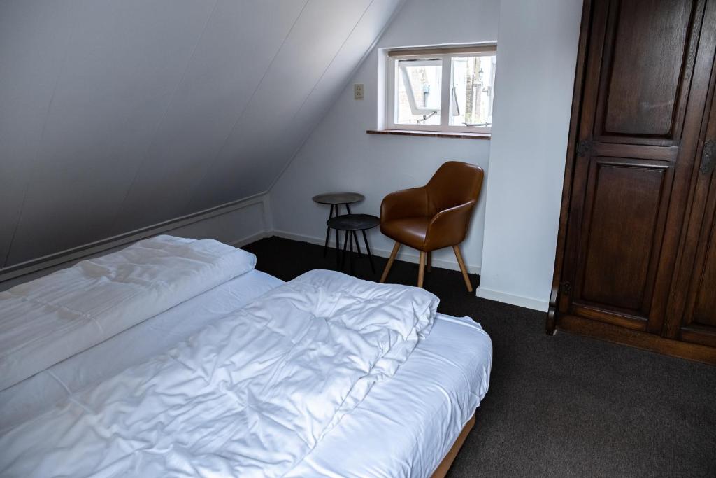 Een bed of bedden in een kamer bij De Soeten Inval