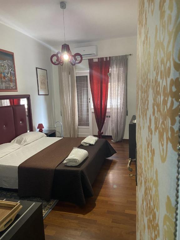 a bedroom with a bed and a red curtain at Bed and Breakfast Impruneta28 in Rome