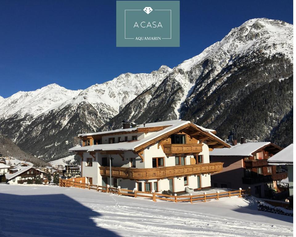 a ski lodge in front of a snow covered mountain at A CASA Aquamarin in Sölden