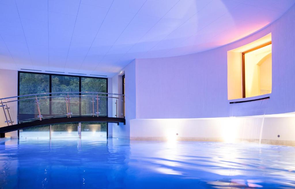 an empty room with a large pool of water at 6717 Nature Hôtel &amp; Spa Le Clos des Délices in Ottrott