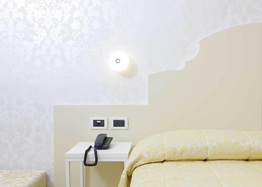 Postel nebo postele na pokoji v ubytování Hotel Adriatico