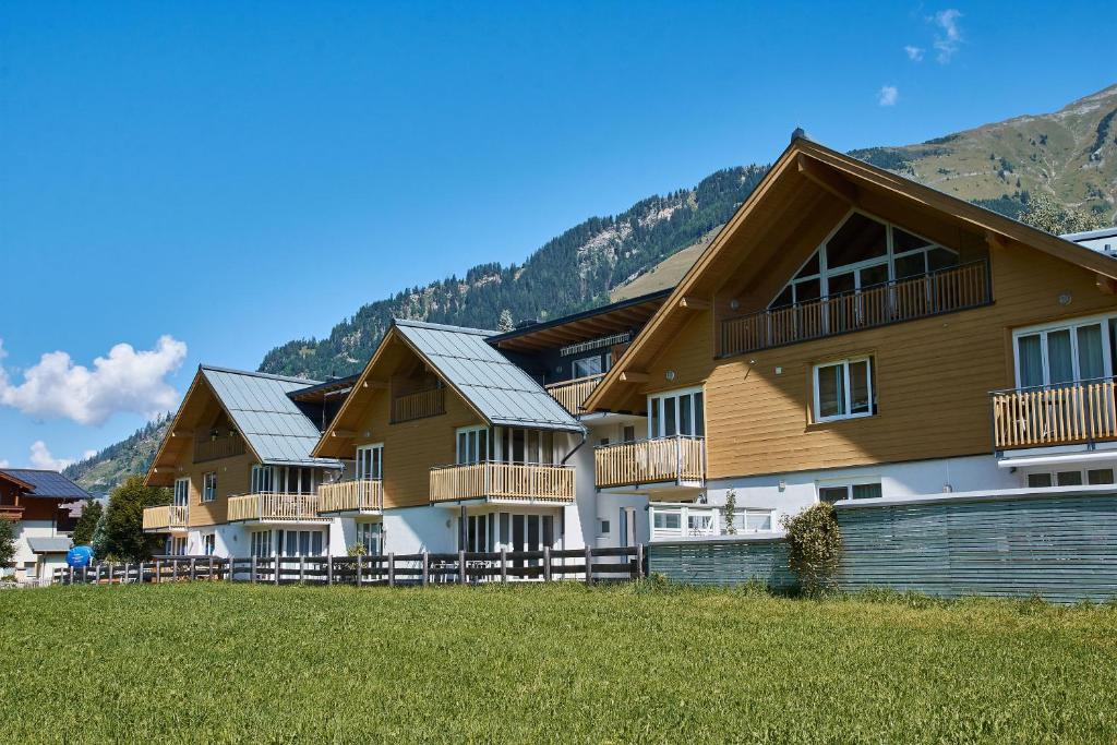 a row of houses with mountains in the background at Mountain View Ski Apartment Rauris in Rauris