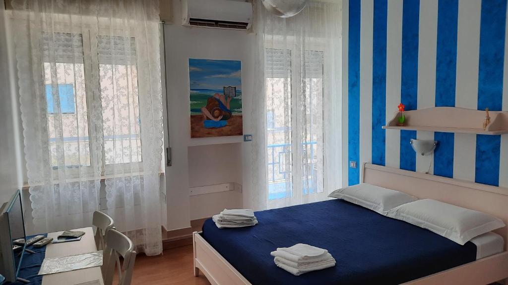 Postel nebo postele na pokoji v ubytování B&B Una Rotonda sul mare
