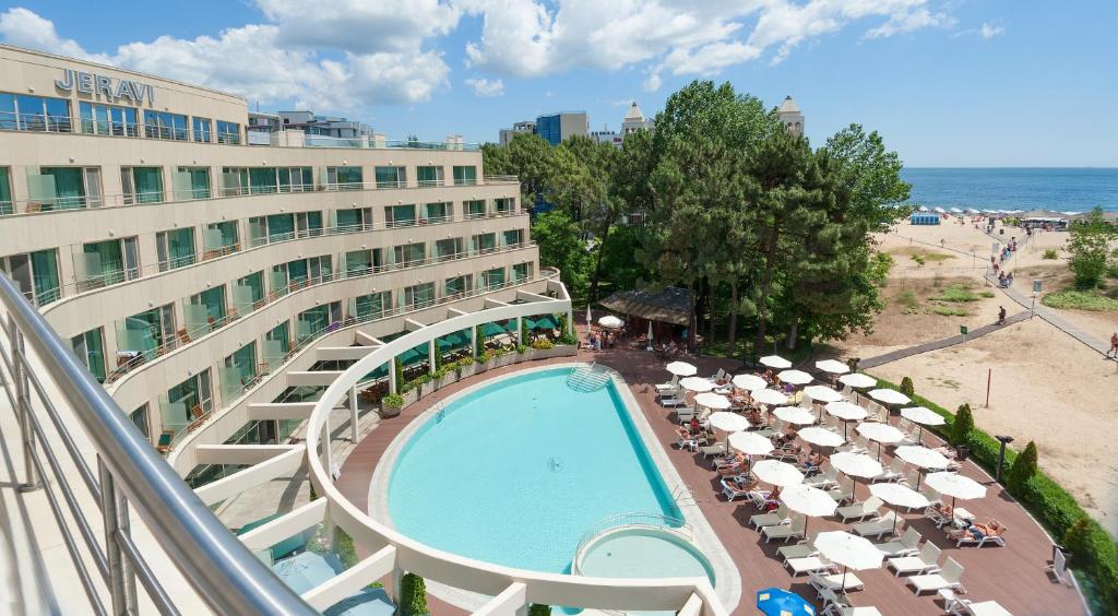 a hotel with a swimming pool next to a beach at Jeravi Beach Hotel - All Inclusive in Sunny Beach