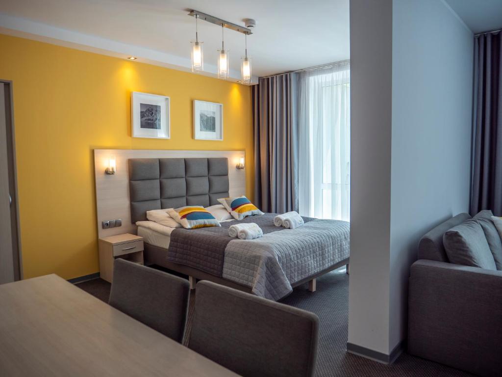 um quarto de hotel com uma cama e uma mesa em Kolejarz Natura Tour em Zakopane