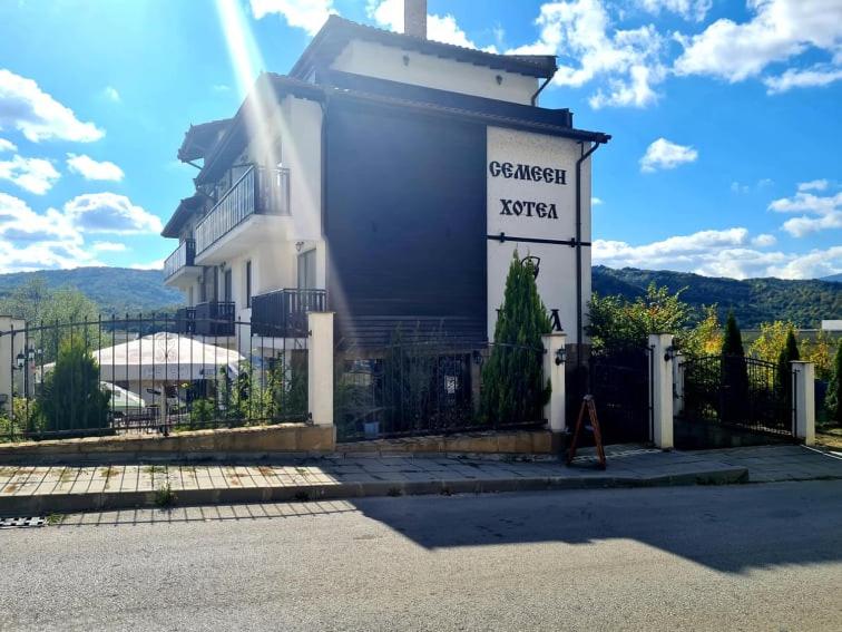 a building with a sign in front of it at Family Hotel Bela in Tryavna