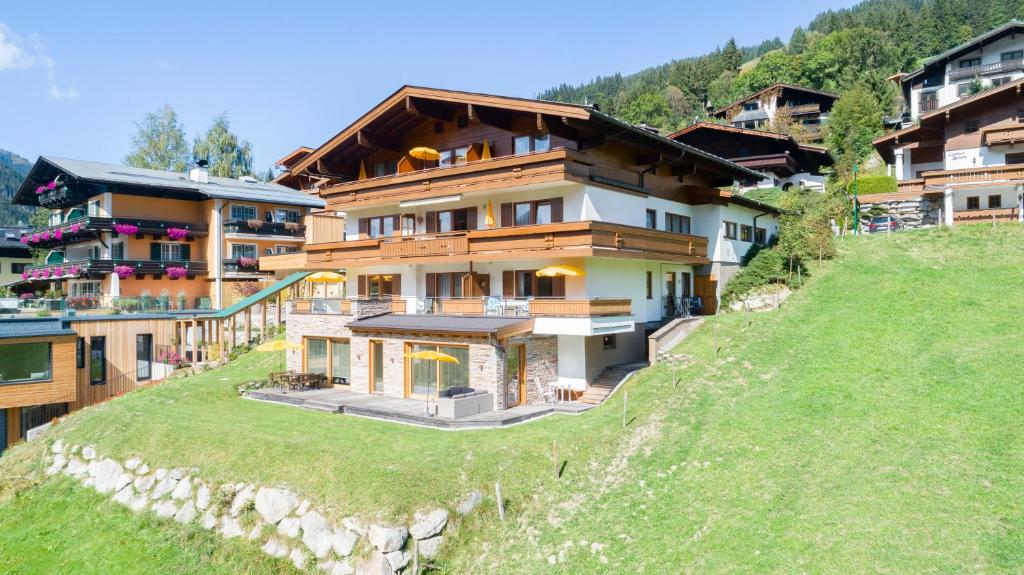 a house on top of a hill with houses at Appartement Schöne Aussicht in Saalbach Hinterglemm