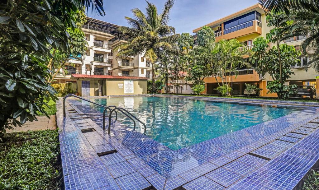 a swimming pool in a building with a resort at Treebo Aquamarine Arpora With Pool in Arpora