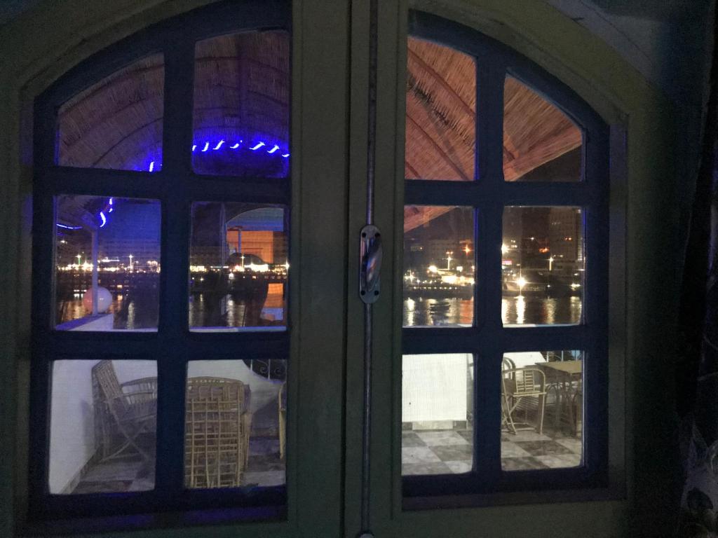 an open door with a view of a city seen through at Nubian Paradise in Aswan