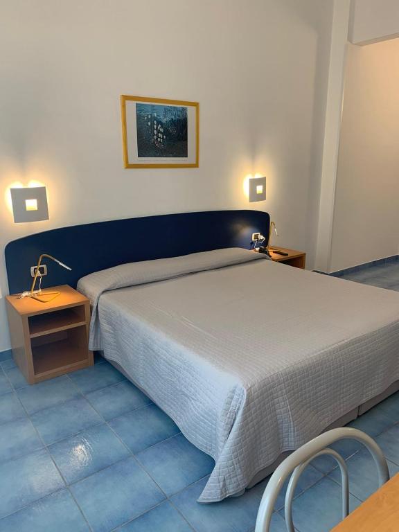 a bedroom with a bed and a table and lights at Residence Panoramic in Maiori
