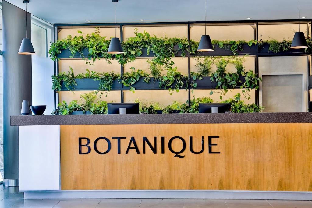 a sign for a botanical office with plants at Botanique Hotel Prague in Prague