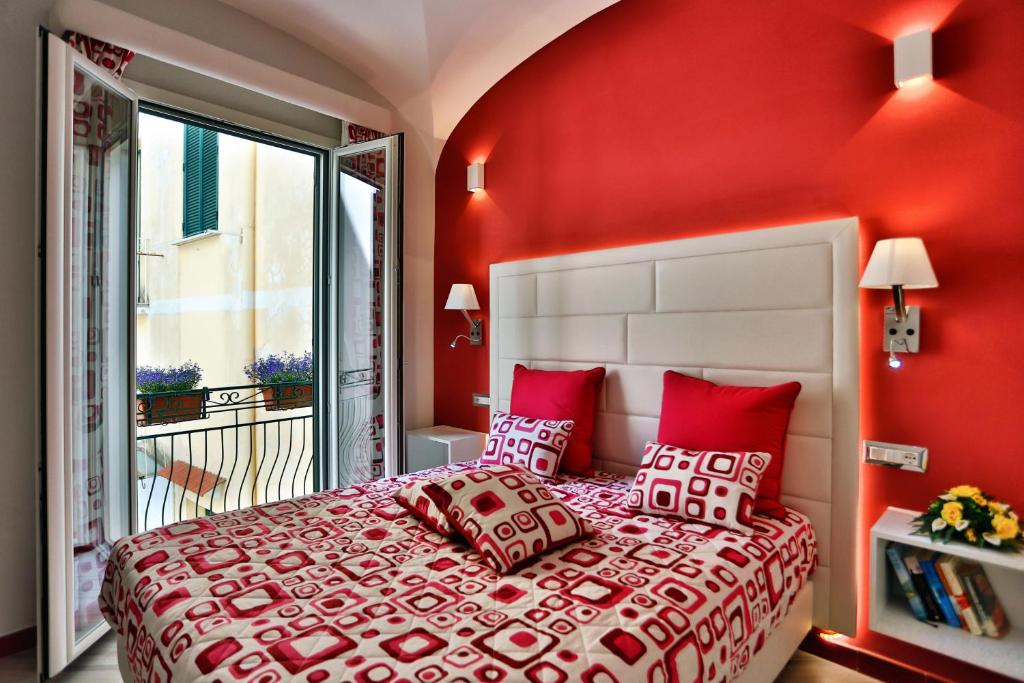 a bedroom with red walls and a bed with red pillows at Apartments Amalfi Design in Amalfi