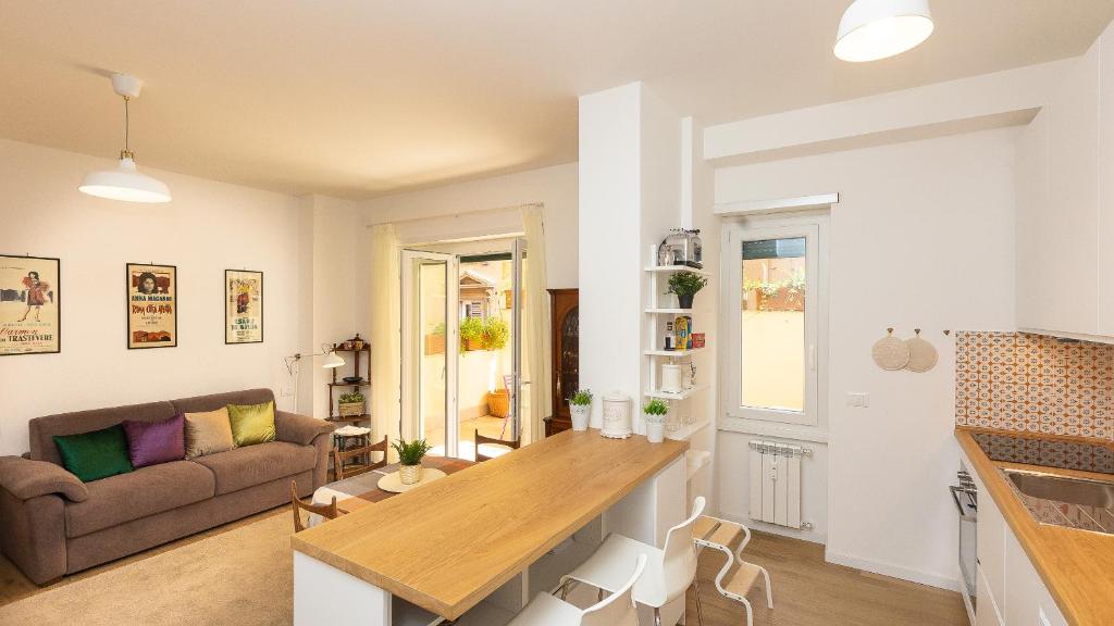 a kitchen and living room with a table and a couch at Rental in Rome - Annietta in Rome