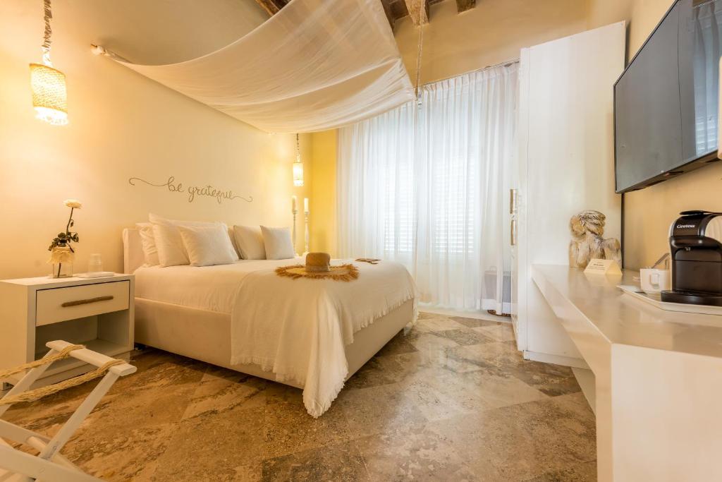 Postel nebo postele na pokoji v ubytování Casa Diluca Cartagena Hotel Boutique