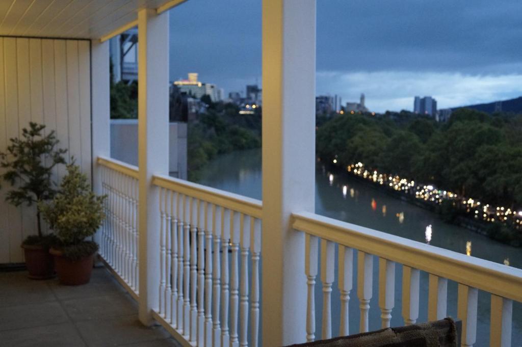 a balcony with a view of a river at Boutique Hotel in Tbilisi City
