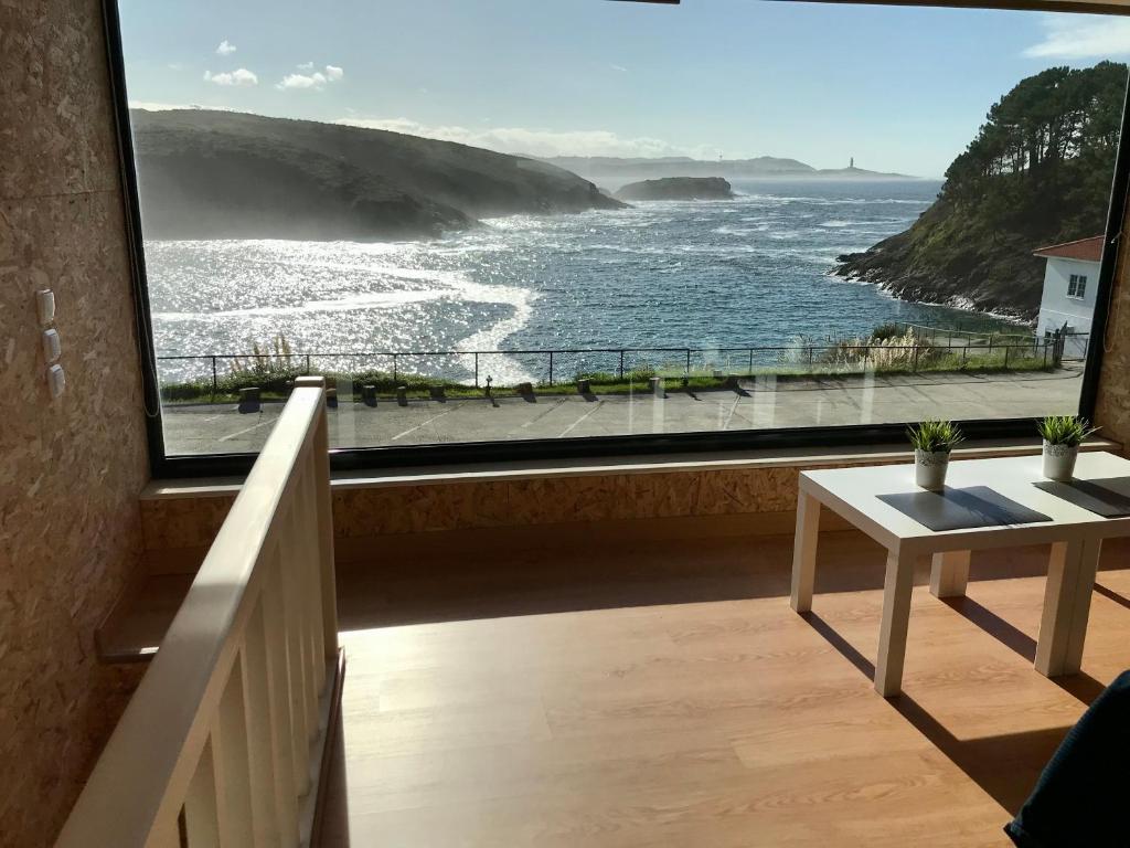 a room with a large window with a view of the ocean at Vistas al mar 2 Canabal in A Coruña