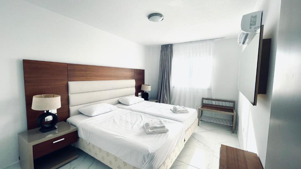 a hotel room with two beds and a window at Fotoxenia Luxury Apts in Paralimni