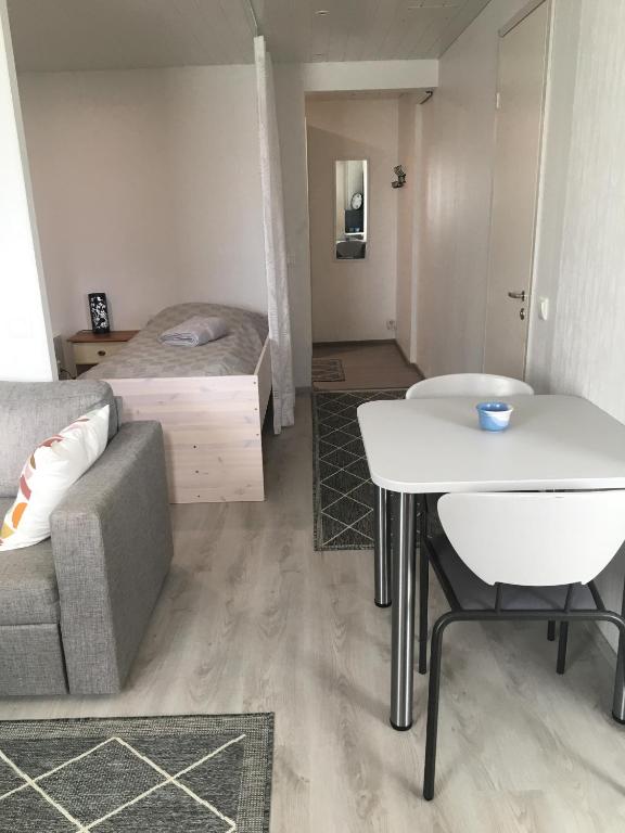 a living room with a couch and a bed at MajoitusMattila in Ylivieska