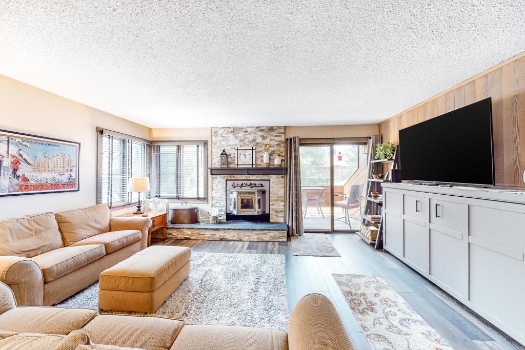 a living room with a couch and a tv at Sunrise 8 in Mammoth Lakes