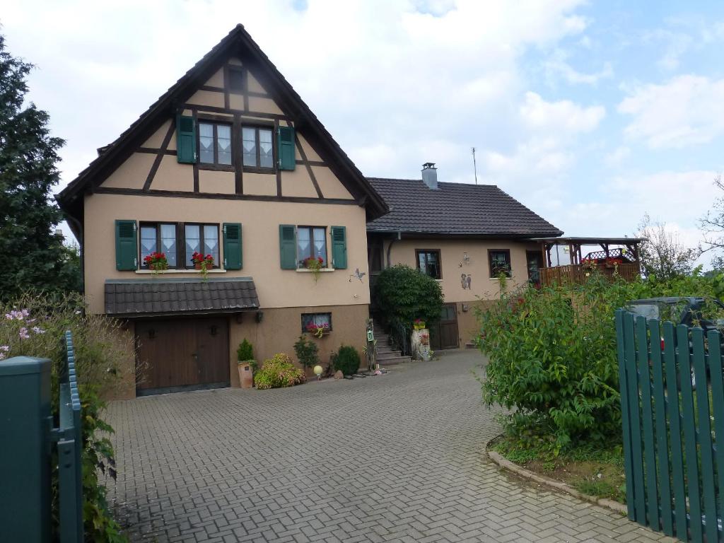 a house with a driveway in front of it at Gite 3 Frontières in Hagenthal-le-Bas