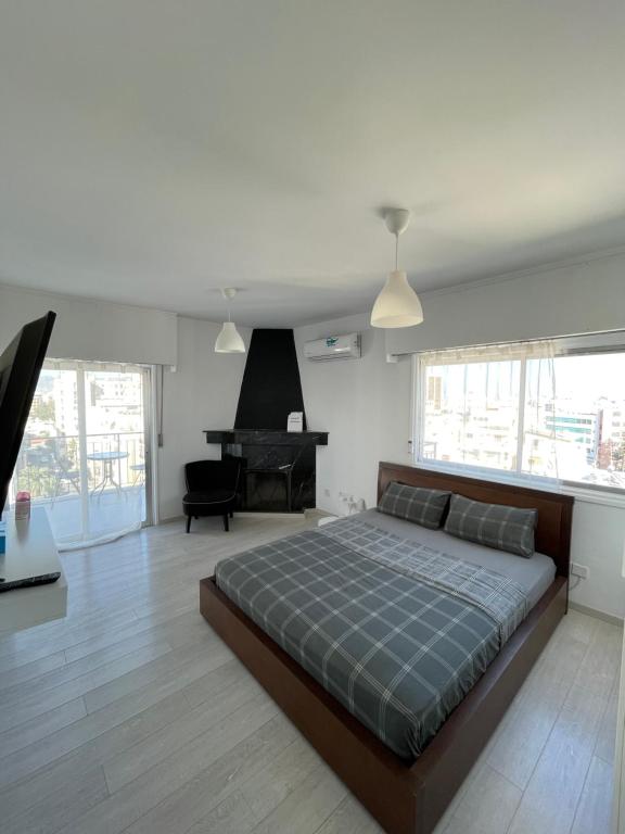 a bedroom with a large bed and a piano at Top floor apartment in Nicosia with view! in Nicosia