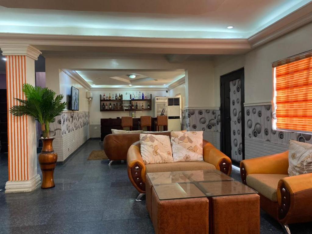 a living room with two couches and a table at Galpin Suites in Lagos